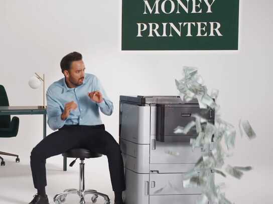 “Raindrop ‘Don’t Break the Money Printer’ campaign – office worker stopping a malfunctioning money printer”